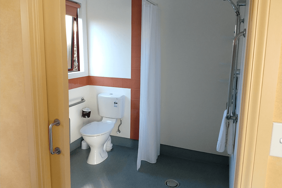 Red Tussock's accessible te anau accommodation bathroom with toilet and wet floor shower.